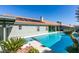 Inviting pool area with desert landscaping, solar panels, and a covered patio for relaxing and enjoying the outdoors at 9031 W Cherokee Ave, Las Vegas, NV 89147