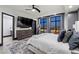 Cozy bedroom featuring city views, a plush bed, and a mounted TV at 9101 Alta Dr # 1206, Las Vegas, NV 89145