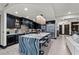 Modern kitchen featuring dark cabinetry, a waterfall island, and stainless steel appliances at 9101 Alta Dr # 1206, Las Vegas, NV 89145