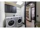 Convenient laundry room with modern washer and dryer, storage cabinets, and sleek design at 9101 Alta Dr # 1206, Las Vegas, NV 89145