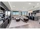 Open-concept living area with a large sofa and an adjacent modern kitchen with an island and city views at 9101 Alta Dr # 1206, Las Vegas, NV 89145