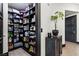 Well-organized walk-in pantry with shelving stocked with food items, and wood look flooring at 9101 Alta Dr # 1206, Las Vegas, NV 89145