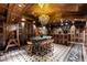 A unique wine room with custom shelving, seating, and ornate chandelier lighting at 9101 Alta Dr # 1206, Las Vegas, NV 89145