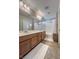 Bathroom featuring double sinks, wooden cabinetry, and a shower-tub combo at 9137 Entrancing Ave, Las Vegas, NV 89149