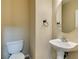 Powder bathroom featuring tile flooring, a pedestal sink, and a round mirror at 9529 Windsor Forest Ct, Las Vegas, NV 89123