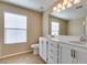 Bathroom featuring double sinks, white cabinets, a large mirror, and tile flooring at 9529 Windsor Forest Ct, Las Vegas, NV 89123