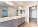 The bathroom features a double sink vanity with a large mirror and neutral tile flooring at 10858 La Florentina Ave, Las Vegas, NV 89166