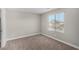 Light-filled bedroom with neutral paint, carpet, and a window with a view of the neighborhood at 10963 Mount Goyer St, Las Vegas, NV 89141