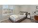 Staged bedroom featuring a cozy bed and an elegant writing desk near a window offering natural light at 10963 Mount Goyer St, Las Vegas, NV 89141