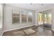 Bedroom with three windows and a sliding glass door with access to the backyard at 10963 Mount Goyer St, Las Vegas, NV 89141
