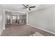 Large bonus room with an open floor plan, neutral paint and carpet, and a modern ceiling fan at 10963 Mount Goyer St, Las Vegas, NV 89141