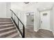 Bright entryway with wood-look tile floors, staircase with railing, and views into a living space at 10963 Mount Goyer St, Las Vegas, NV 89141