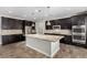 Modern kitchen with stainless steel appliances, granite countertops, and dark wood cabinets at 10963 Mount Goyer St, Las Vegas, NV 89141