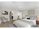 Staged main bedroom showcasing a comfortable bed, a cozy chair, and ensuite bathroom access at 10963 Mount Goyer St, Las Vegas, NV 89141