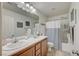 This bathroom features a tile floor, and a large mirror above the single sink vanity at 10990 Mountain Willow St, Las Vegas, NV 89179