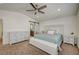 Stylish bedroom with neutral tones, complete with a ceiling fan and complementary white furniture at 10990 Mountain Willow St, Las Vegas, NV 89179