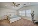 Bright bedroom featuring a ceiling fan, plush carpet, and large windows providing ample natural light at 10990 Mountain Willow St, Las Vegas, NV 89179