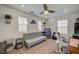 Bright bonus room with neutral carpet, ceiling fan, and multiple windows for ample natural light at 10990 Mountain Willow St, Las Vegas, NV 89179