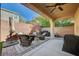 Inviting covered patio area with wicker furniture, ideal for outdoor dining and entertaining guests at 10990 Mountain Willow St, Las Vegas, NV 89179