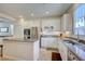 Bright kitchen featuring stainless steel appliances, granite countertops, and white cabinets at 10990 Mountain Willow St, Las Vegas, NV 89179