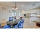 Modern kitchen featuring white cabinetry, stainless steel appliances, and a breakfast bar with stylish seating at 10990 Mountain Willow St, Las Vegas, NV 89179