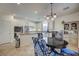 Modern kitchen with stainless steel appliances, granite countertops, white cabinets, and a stylish dining area at 10990 Mountain Willow St, Las Vegas, NV 89179