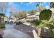 Charming backyard with mature trees and desert landscaping, as well as a stone patio and dining set at 1312 Rolling Sunset St, Henderson, NV 89052