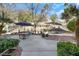 Outdoor patio area features a dining table with a garden view and mature desert landscaping at 1312 Rolling Sunset St, Henderson, NV 89052