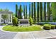 Capistrano community sign amidst manicured landscaping, tall trees, and green lawn creating a picturesque entrance at 1312 Rolling Sunset St, Henderson, NV 89052