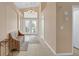 Inviting foyer with high ceilings, neutral paint, and a charming bench for added convenience at 1312 Rolling Sunset St, Henderson, NV 89052