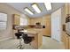 Well-lit kitchen featuring an island, granite counters, and modern appliances at 1312 Rolling Sunset St, Henderson, NV 89052