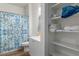 Bathroom featuring patterned shower curtain, a toilet and shelving with towels at 1410 Pink Dawn Dr, Henderson, NV 89014