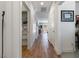Hallway featuring wood floors, storage closet, and modern decor at 1410 Pink Dawn Dr, Henderson, NV 89014