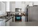 Well-equipped kitchen with stainless steel appliances, solid surface countertops, and ample cabinet space at 1410 Pink Dawn Dr, Henderson, NV 89014