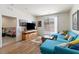 Open-concept living area with sliding glass doors, entertainment center, and comfortable seating at 1410 Pink Dawn Dr, Henderson, NV 89014
