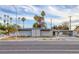 Modern home with a gray exterior, palm trees, and a unique lattice design on the front, offering stylish curb appeal at 1657 E Desert Inn Rd, Las Vegas, NV 89169