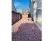 Small backyard area featuring decorative rock covering and a concrete block wall, with a condenser unit installed at 1960 Verbania Dr, Las Vegas, NV 89134