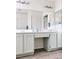Bathroom vanity featuring double sinks, vanity seating area, large mirror, and ample storage space at 1960 Verbania Dr, Las Vegas, NV 89134