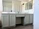 Bathroom vanity featuring double sinks, plenty of storage, with wood look floors at 1960 Verbania Dr, Las Vegas, NV 89134