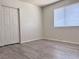 Bedroom featuring a large closet, light gray laminate flooring, and a large window for natural light at 1960 Verbania Dr, Las Vegas, NV 89134