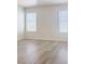 This bedroom features gray wood-look flooring and bright natural light at 1960 Verbania Dr, Las Vegas, NV 89134