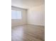 Bedroom featuring a large window for natural light, light gray laminate flooring, and neutral walls at 1960 Verbania Dr, Las Vegas, NV 89134