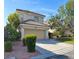 Inviting two-story home with a well-maintained front yard and attached two-car garage at 1960 Verbania Dr, Las Vegas, NV 89134