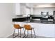 Kitchen featuring dark counter tops, wood flooring and updated appliances at 1960 Verbania Dr, Las Vegas, NV 89134