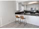 Kitchen featuring dark counter tops, wood flooring and a breakfast bar at 1960 Verbania Dr, Las Vegas, NV 89134