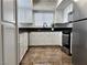 Kitchen featuring stainless appliances, white cabinets, and light from the window at 1960 Verbania Dr, Las Vegas, NV 89134