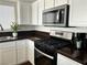 Kitchen featuring a gas range, microwave, and dark countertops at 1960 Verbania Dr, Las Vegas, NV 89134