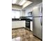 Bright kitchen with stainless steel appliances, white cabinetry, and new floors at 1960 Verbania Dr, Las Vegas, NV 89134