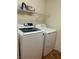 A modern washer and dryer set with overhead storage shelving at 1960 Verbania Dr, Las Vegas, NV 89134