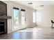 Spacious living room with a fireplace, wood flooring, and access to the backyard at 1960 Verbania Dr, Las Vegas, NV 89134
